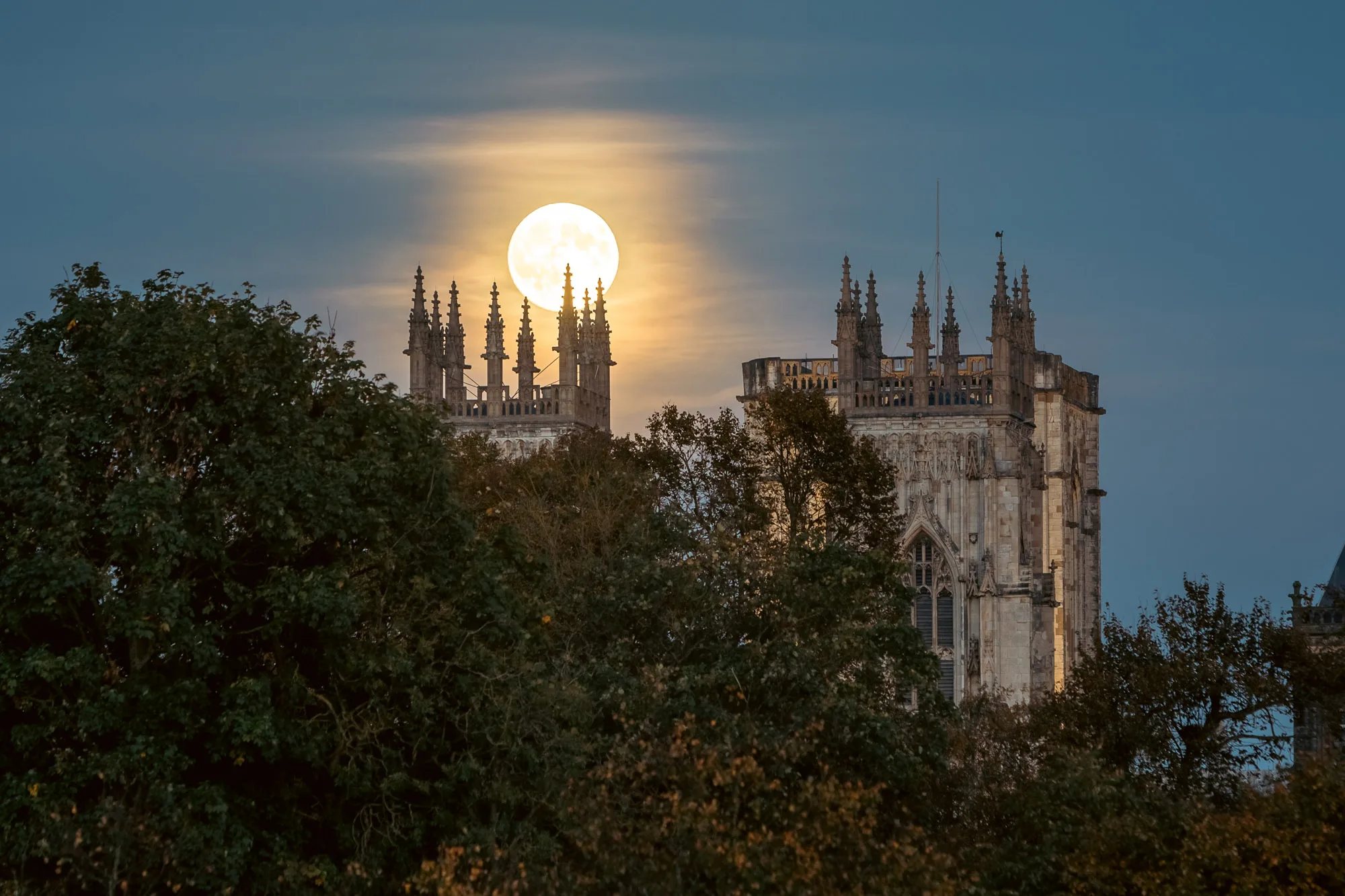 Full Moon Hunter Superman over York Minster at dusk Autumn evening