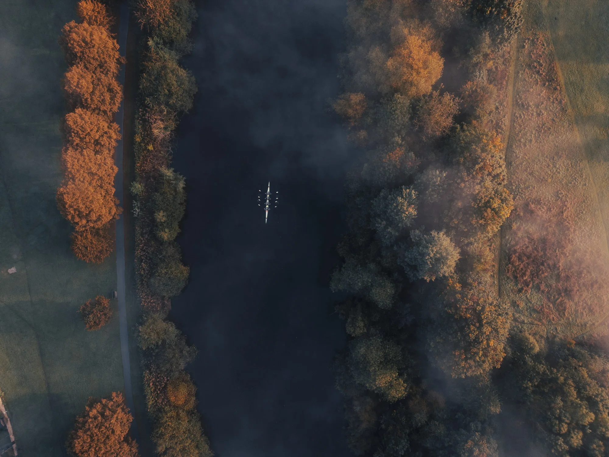 Rowing Boat on River Ouse in York from above on misty Autumn morning